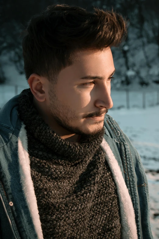 a man standing in the snow with his eyes closed