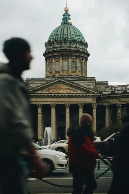 several people and vehicles in front of a building