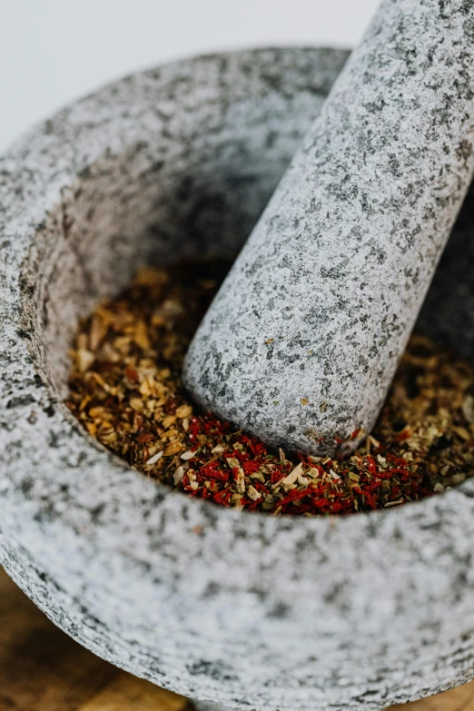 a mortar mortar and bowl of various spices