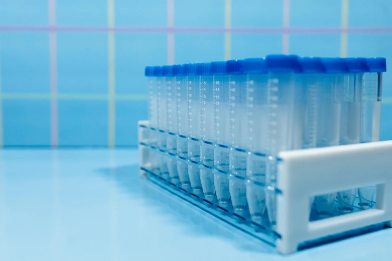 a blue plastic container with six cups on top of it