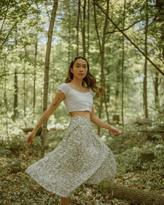 a woman in a forest poses for a portrait