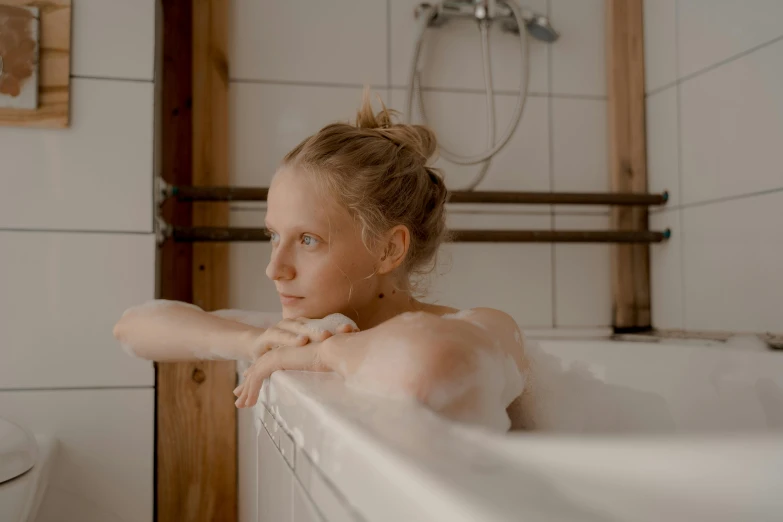 a woman taking a bath and she is sitting down