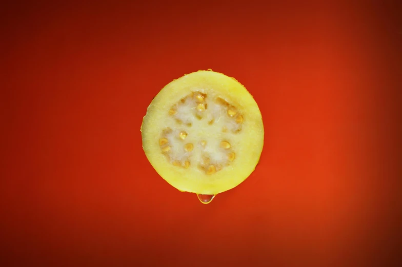 a banana that has been cut open on top of a red surface