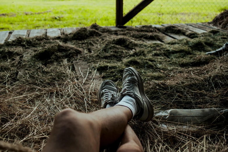 a close up of a person's feet in the grass