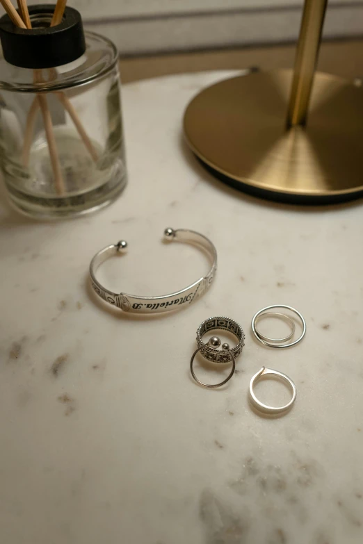 a close up of five rings next to a glass of water