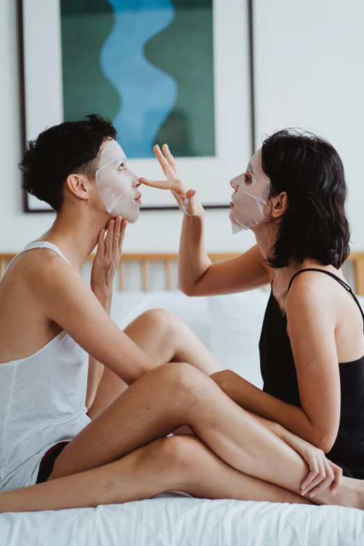 a couple is sitting down with their face masks on