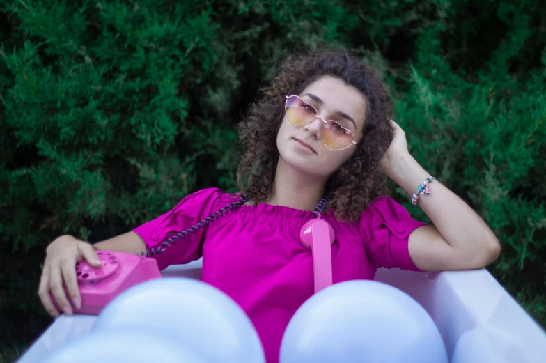 a woman with large afro is wearing pink sunglasses