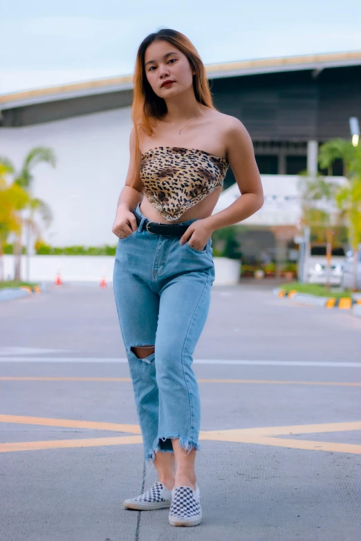 a woman in an animal print top and jeans