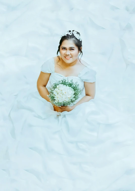 a woman with a bouquet of flowers is in a dress