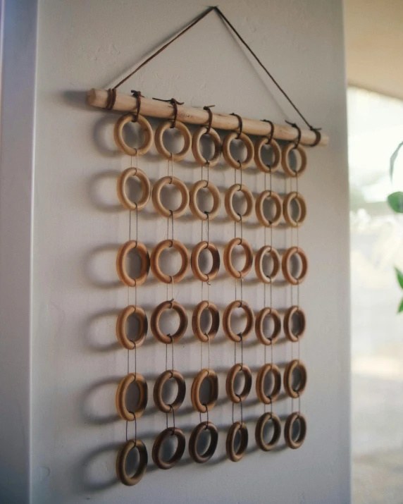 a string wall hanging of wooden circles