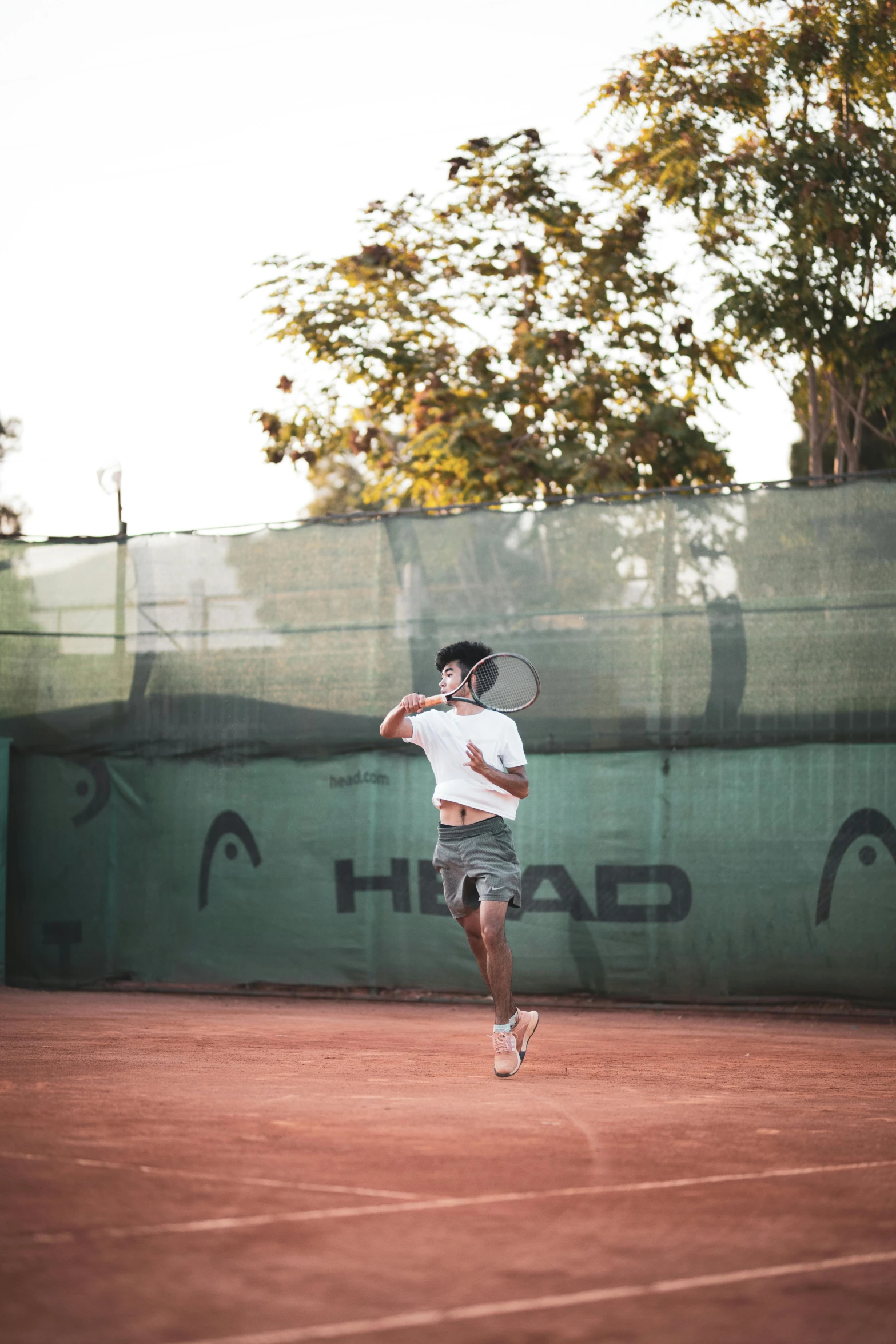 a man is running to hit a tennis ball