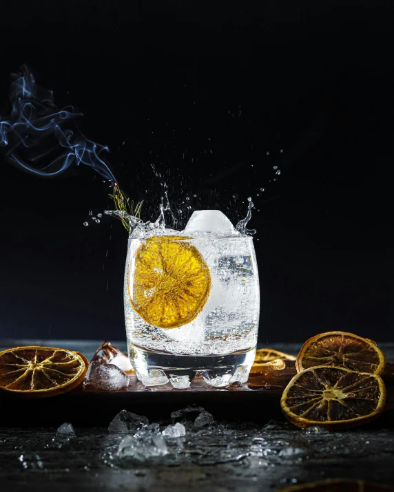 an iced glass that is filled with liquor and orange slices