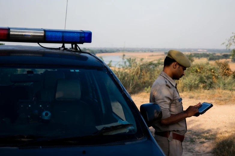 a man standing next to a blue vehicle