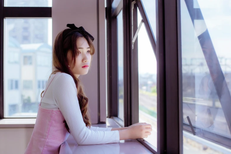 a girl is leaning out of a train window
