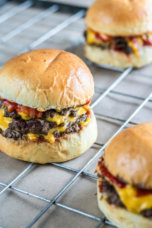 hamburgers on cooling racks are ready to be baked