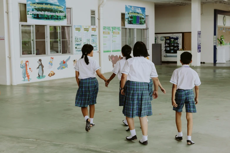 a group of school girls holding hands