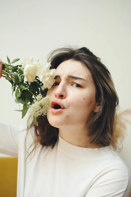 a young woman with flower crown in front of her eyes