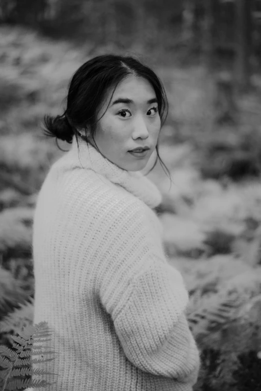 a black and white po of a girl in a sweater