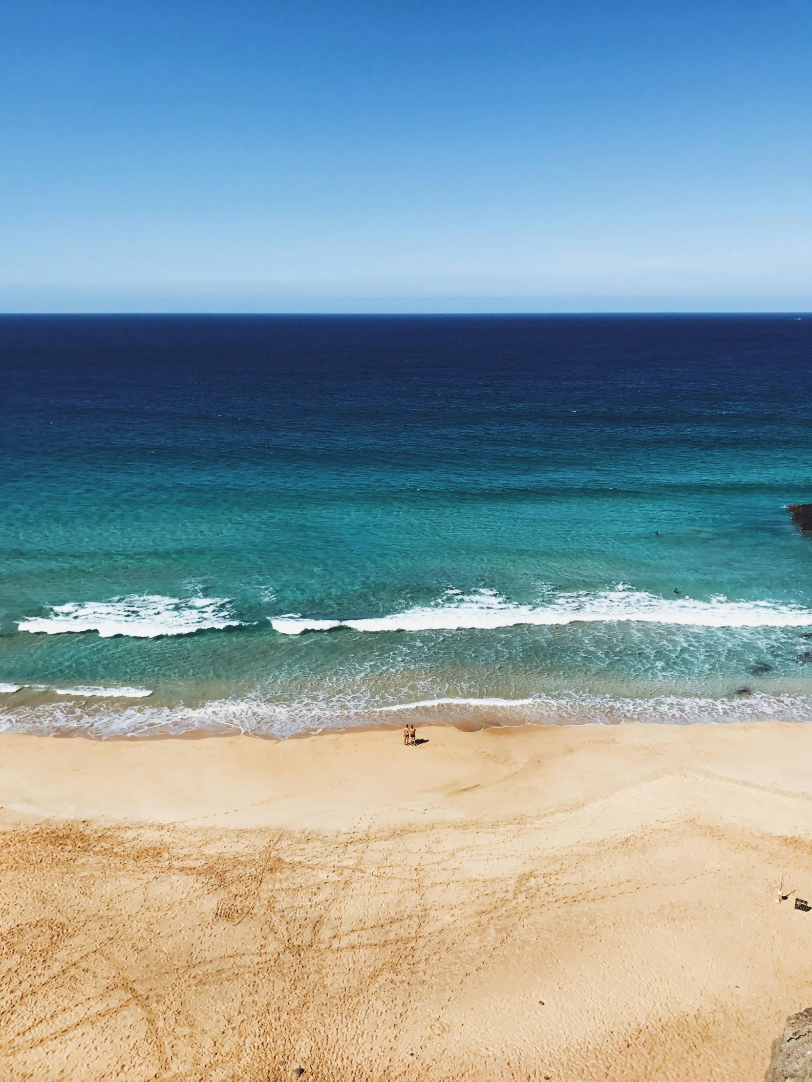 a small group of people on top of a beach