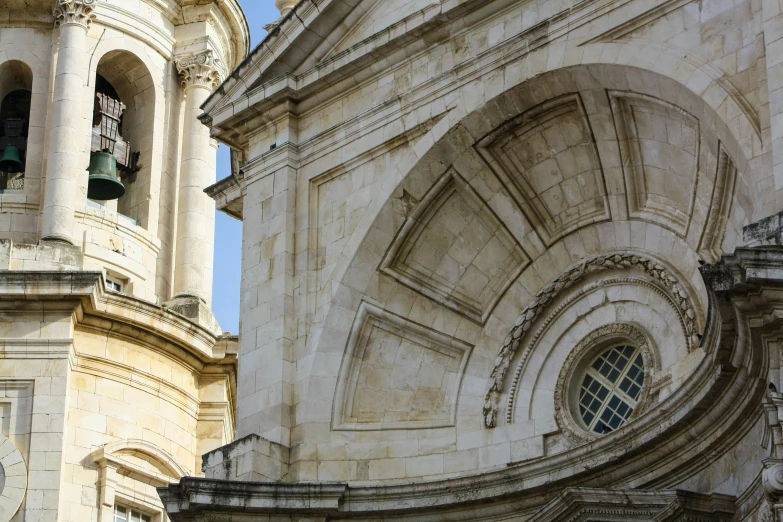 a building with an ornate clock tower and a bell