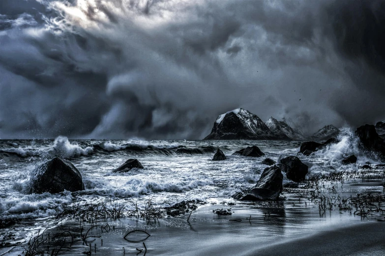 black and white image of a storm approaching the beach