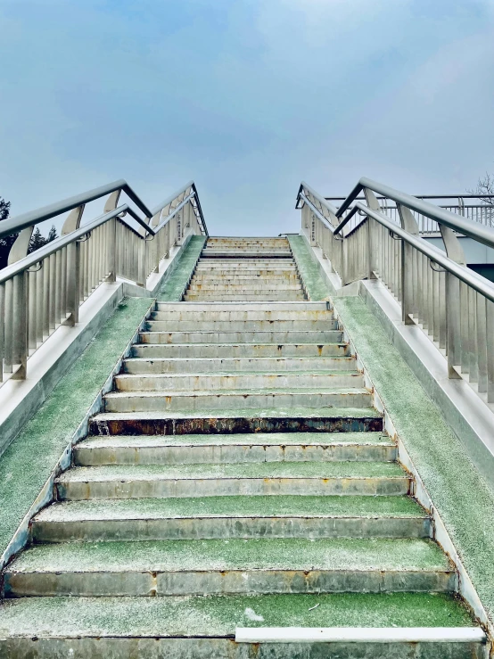 a long staircase with green steps going up