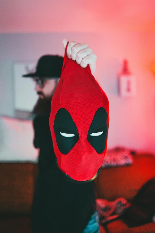 a person with a deadpool hat and sweater