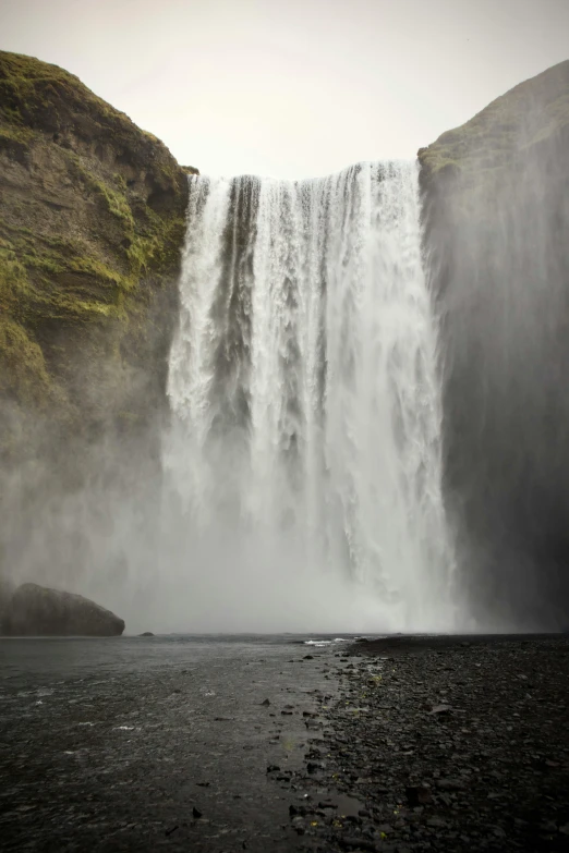 the water sprays from the large waterfall