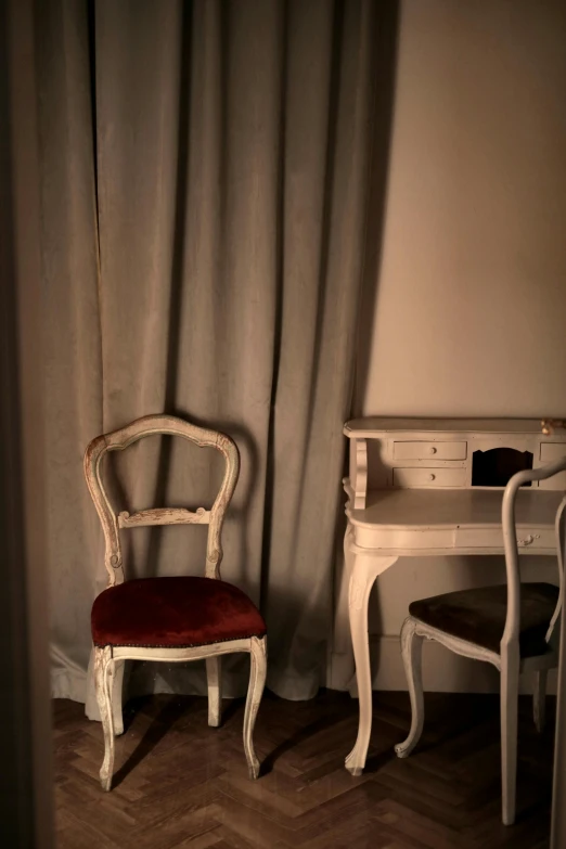 an old white chair and desk are shown