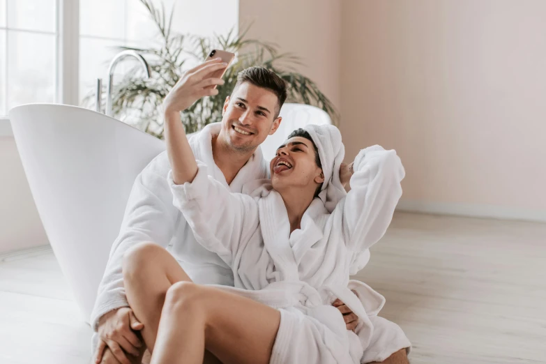 a man and woman in robes sitting on the floor