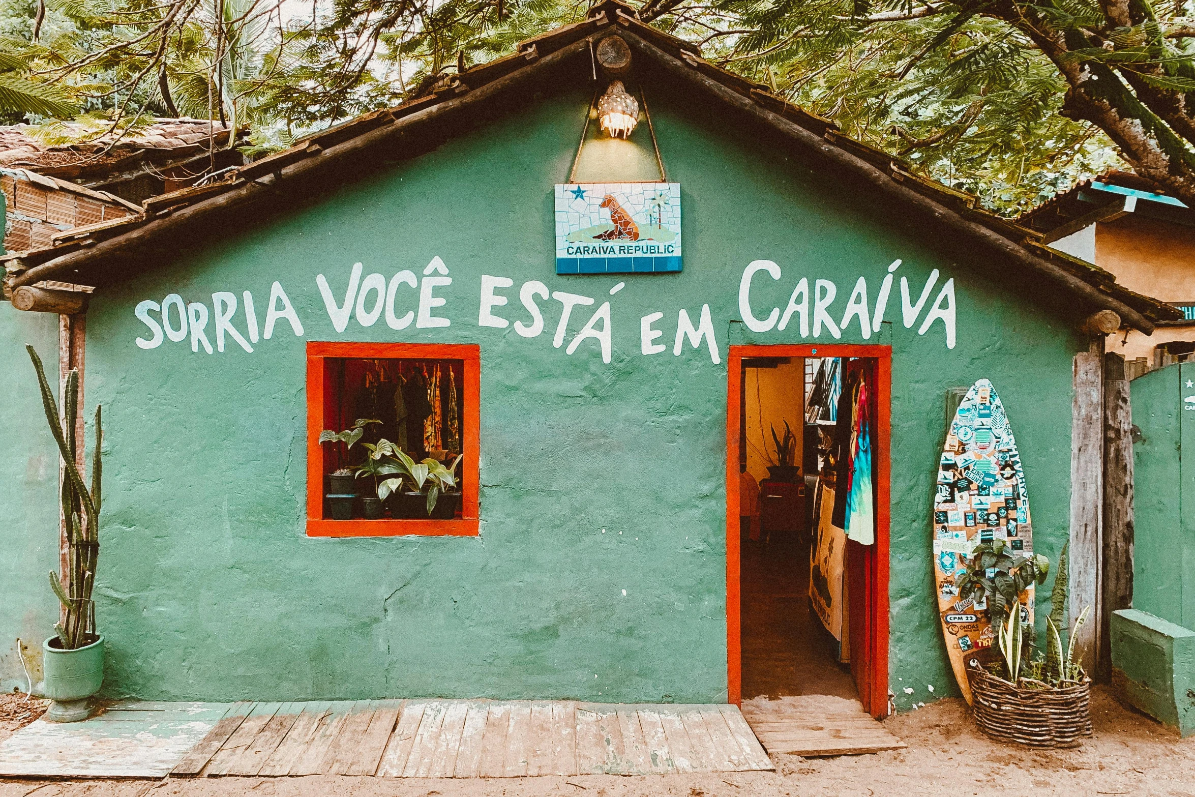 a small surf house is shown with writing on the side