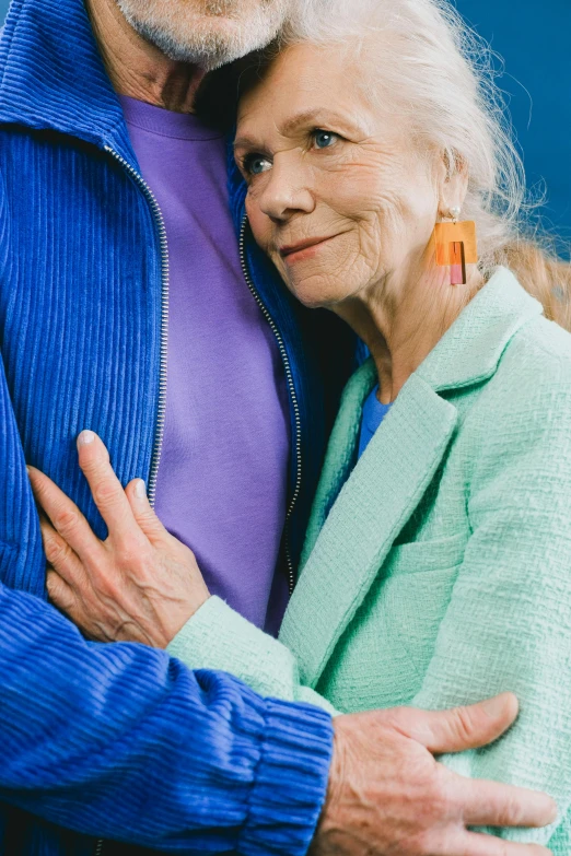 an old couple emcing each other by some water