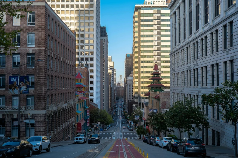 a street is full of buildings and traffic as cars drive down it