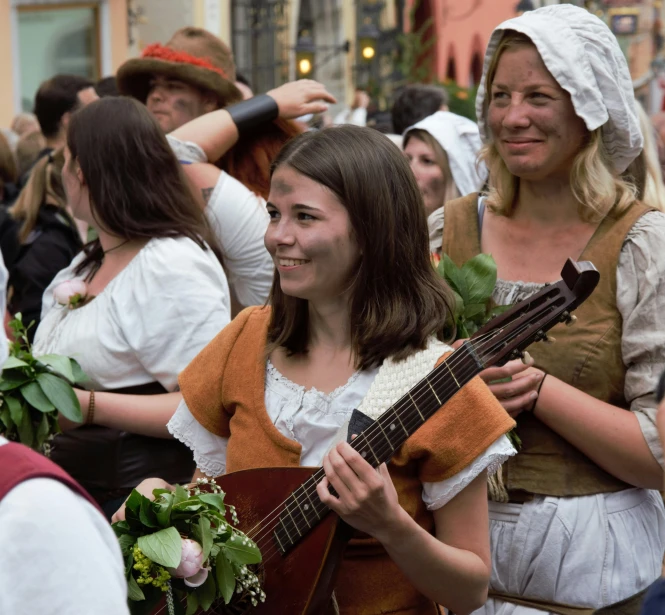 a women that is holding a guitar in her hand