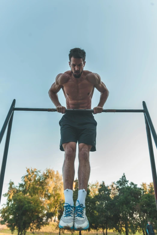 a man holding his back as he is pulling his arms in parallel