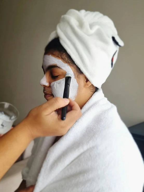 a person with a face mask on putting on soing