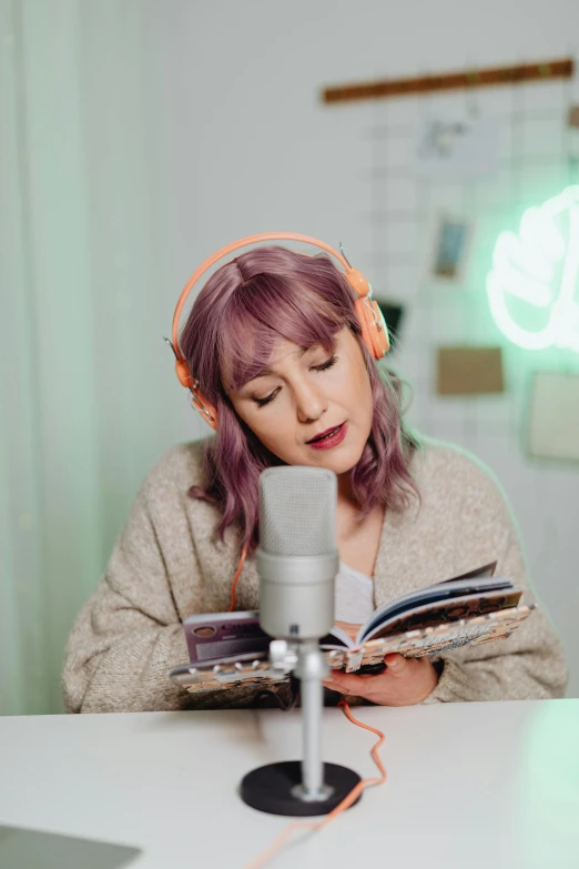 a woman reads a book while sitting at a table