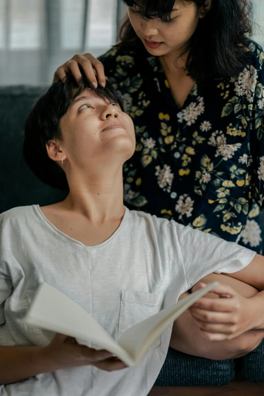 a young woman is getting her hair cut