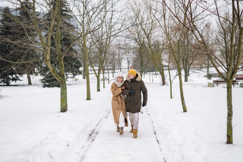 a man and woman walking in the snow together