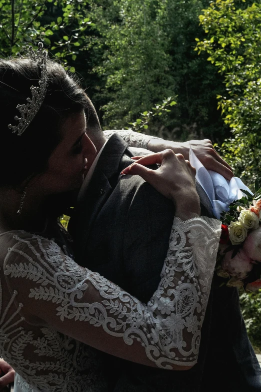 the young bride and groom share a hug