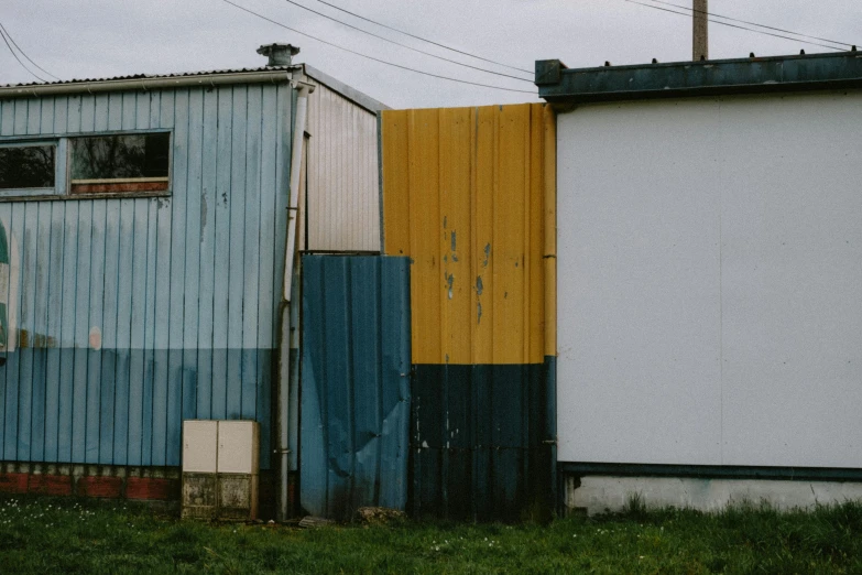 an old, run down building next to other houses