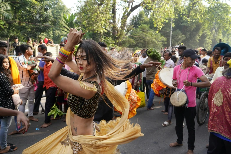 a belly dancer performing in the middle of a crowd