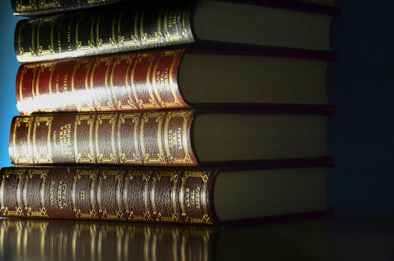 several books are sitting on a table next to the light