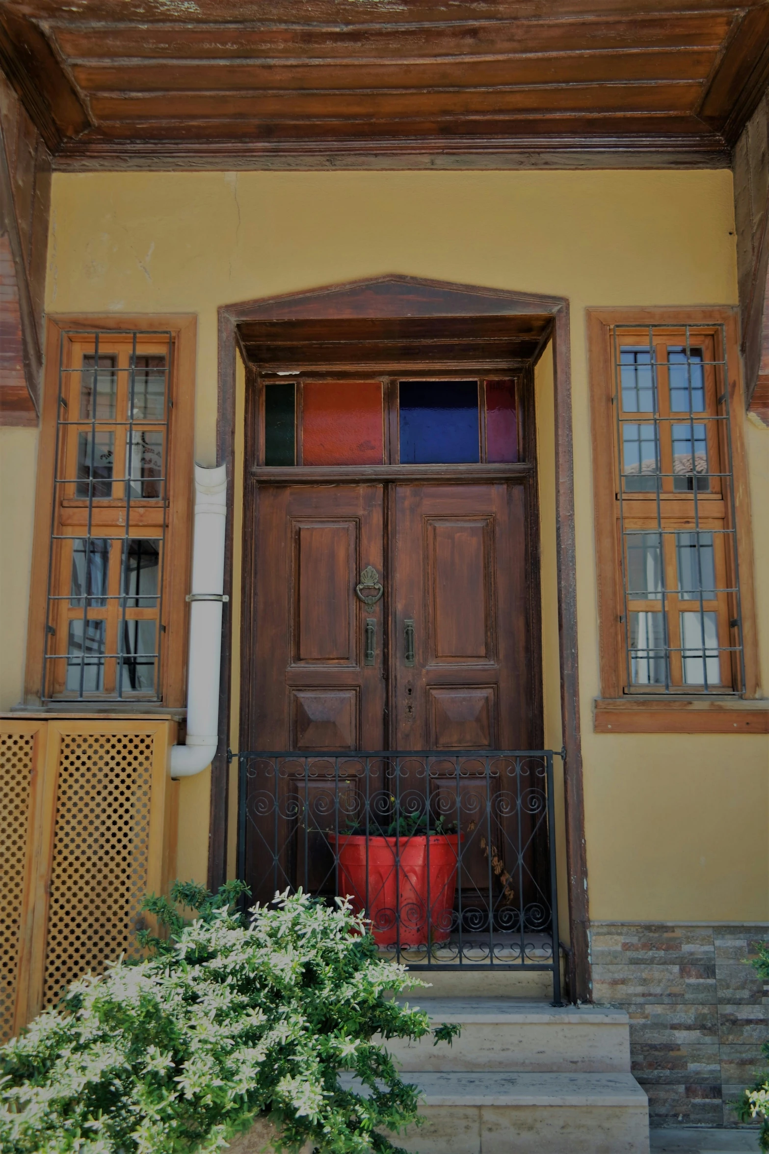 the front of a building with wooden doors