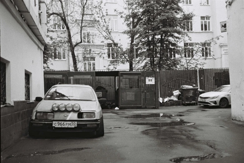 an old car parked on the side of a building