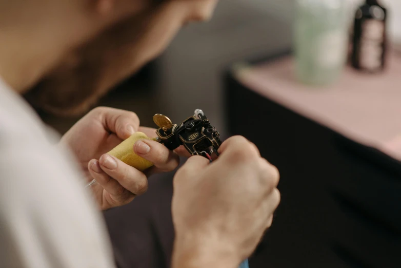 an old man smoking a small device made of circuit board parts