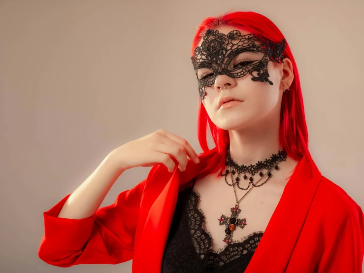 a woman wearing a black lace mask and red hair