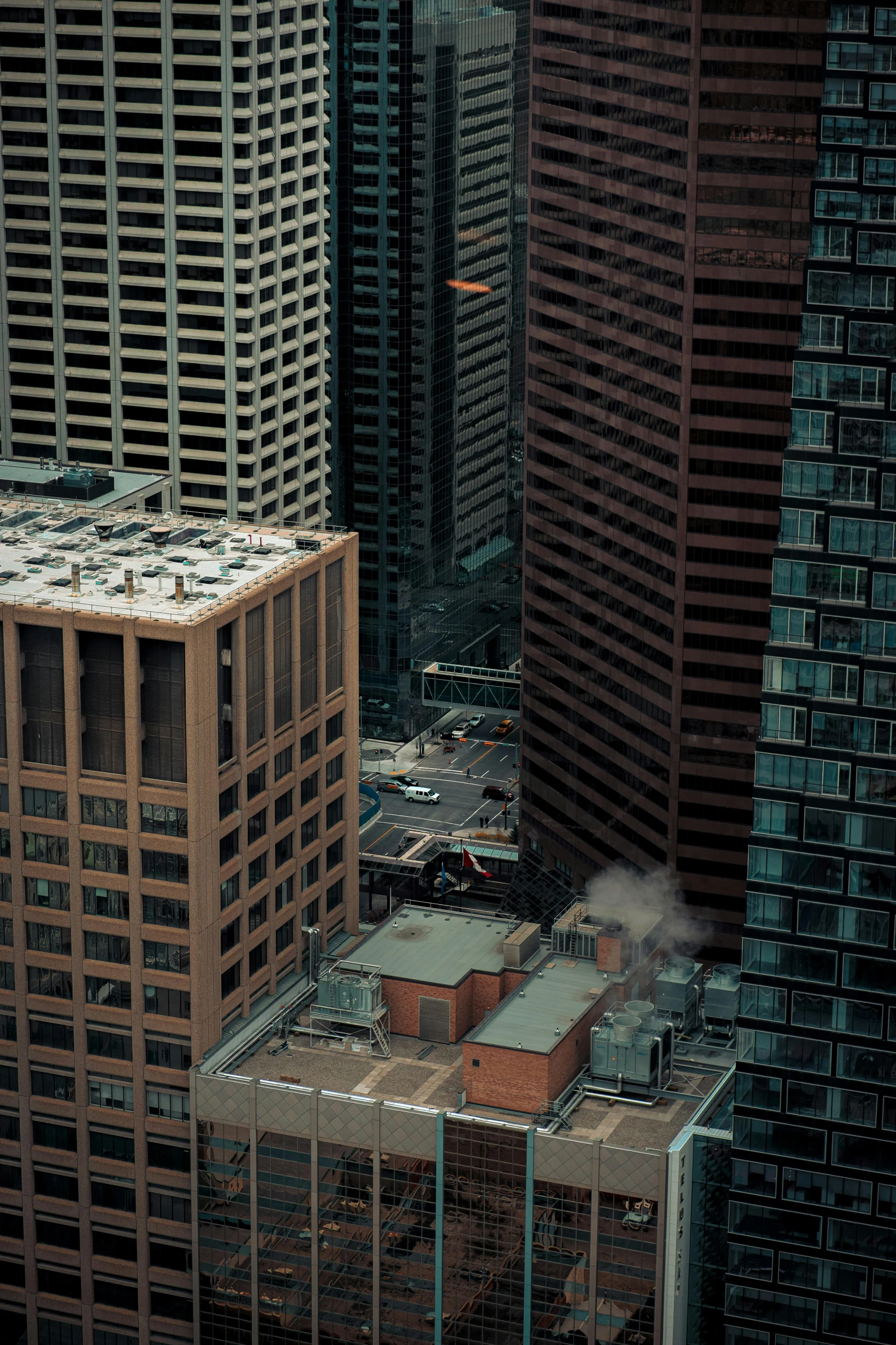 a tall building near two smaller buildings in the city