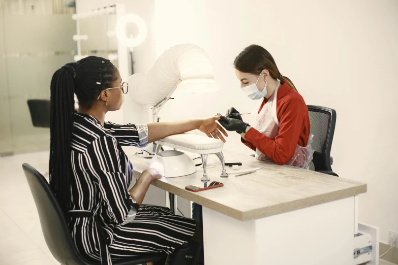 a women who is in the dentist's office and sitting next to another woman