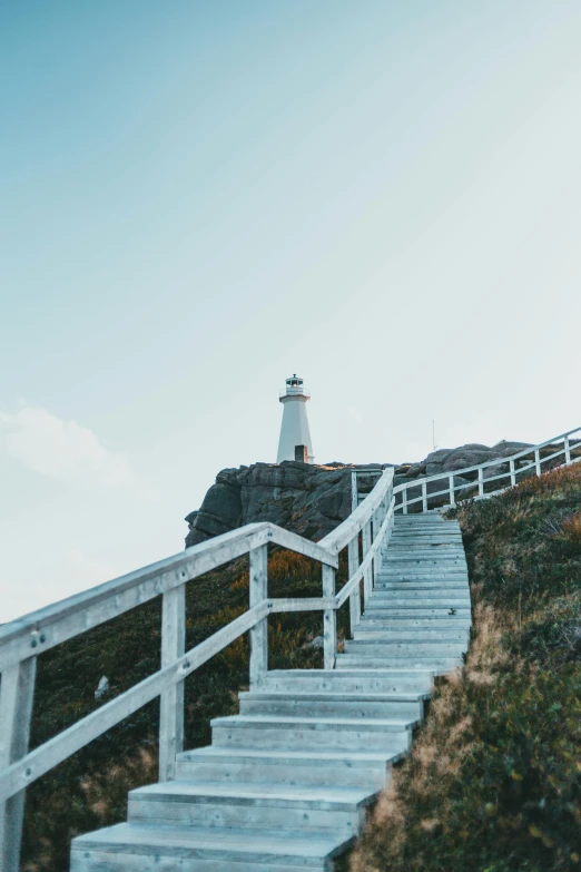 a stairway leading up to a lighthouse in the distance